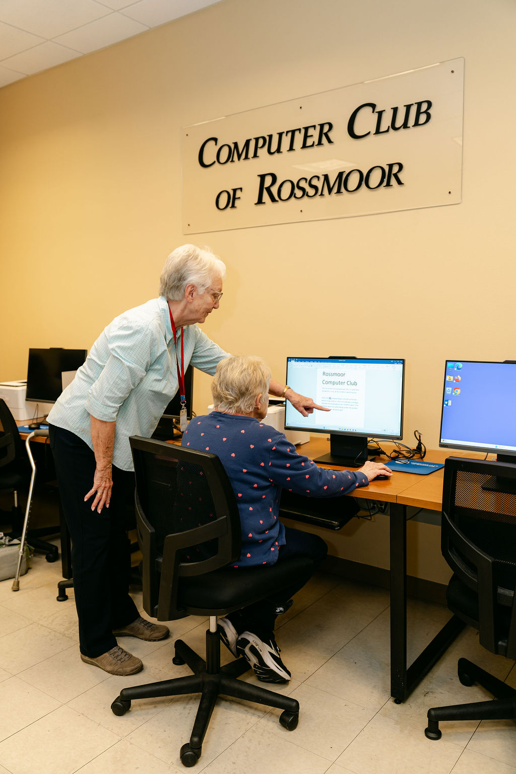 Rossmoor computer club, one resident helps another on the computer.