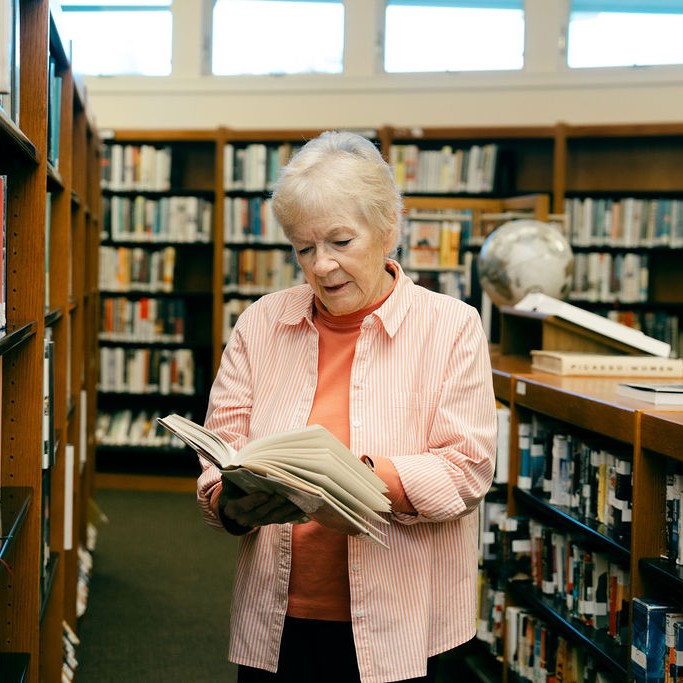 Library- Woman Reads book at the library