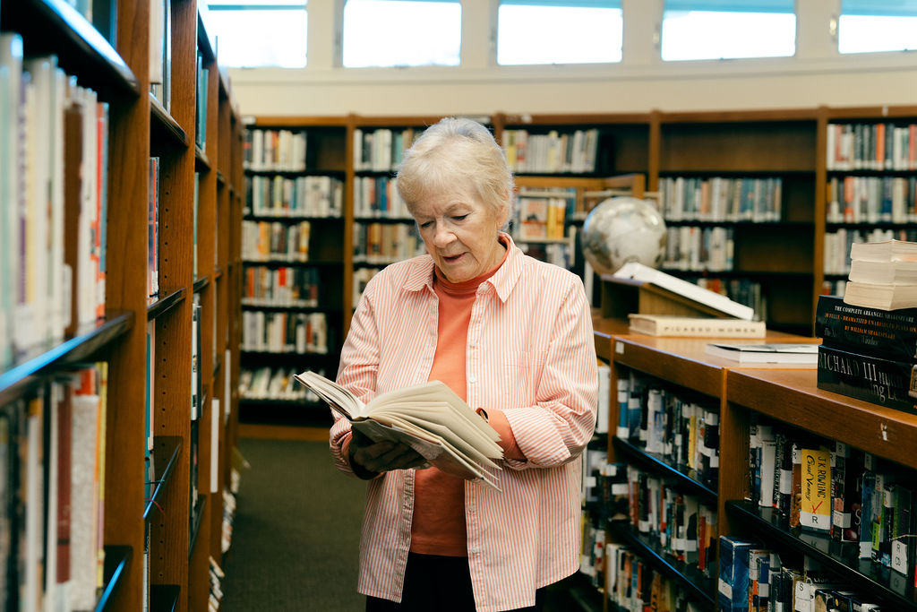Woman Reads book at the library