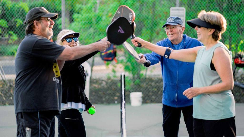 A group taps their paddles together